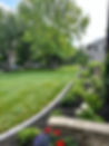 Freshly installed front yard sod with brick-edged garden beds in Winnipeg, Manitoba, by Xtraordinaire Landscapes