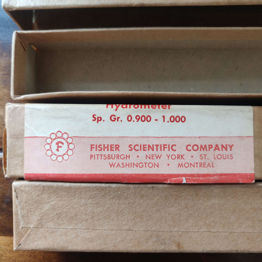two vintage hydrometers in boxes