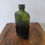 Прев'ю: Antique early 20th century green ribbed poison bottle with original stopper/lid