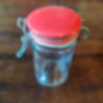 Vintage glass spice jar with metal closing and red top
