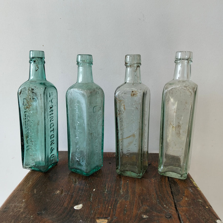 Antique late 19th or early Victorian 20th century set of 4 green bottles