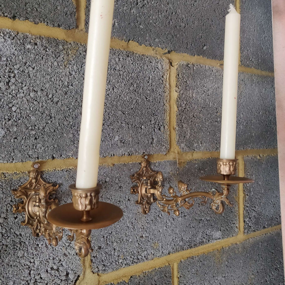 brass scones on wall with candle