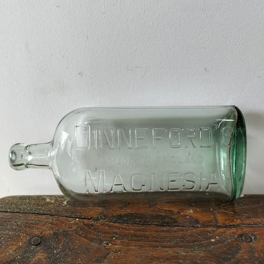 Antique early 20th century embossed Dinneford’s Magnesia bottle pale aqua-green