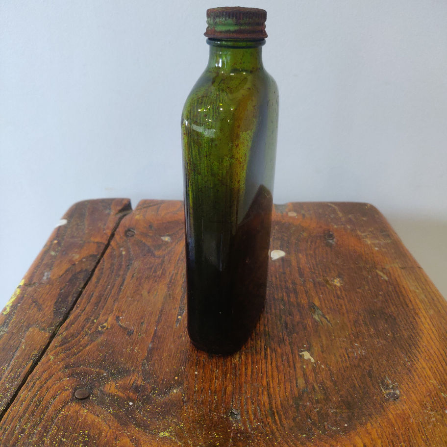 Antique early 20th century green ribbed poison bottle with original stopper/lid
