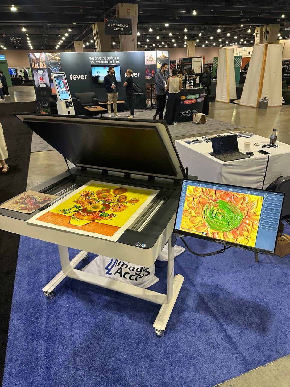 Image Access WideTEK scanner digitizing a Van Gogh sunflower print at the American Alliance of Museums 2026 conference