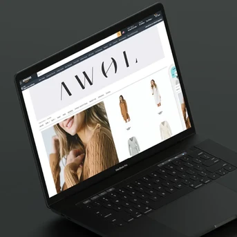 Fashion e-commerce website design for AWOL, showcasing a sleek Amazon storefront with minimalist branding and product listings on a black MacBook Pro