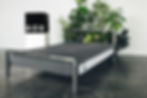oso mattress logo displayed on a box beside a black framed bed