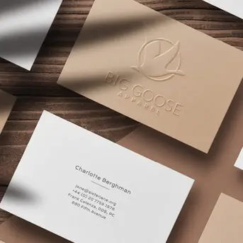 Professional embossed business card design for Big Goose Apparel with a minimalist goose icon and clean typography layout.