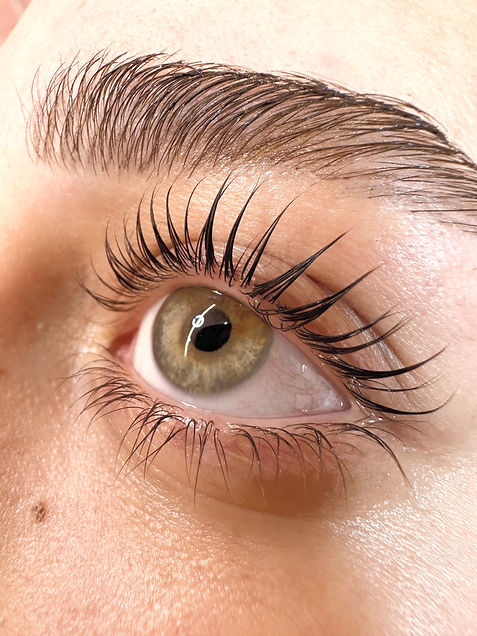 _“Professional close-up of a perfectly executed lash lift and eyebrow shaping, highlightin