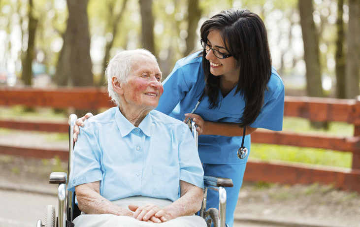 Caregiver-with-woman-in-wheelchair.gif