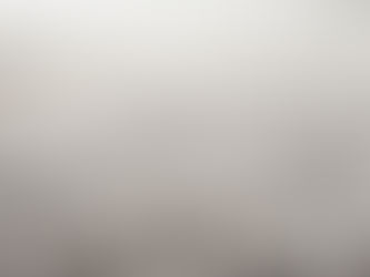 Close-up of a gray shag carpet with soft, fuzzy texture and shallow focus, filling the frame with a cozy neutral look.
