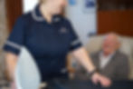 Home care worker ironing for a client 