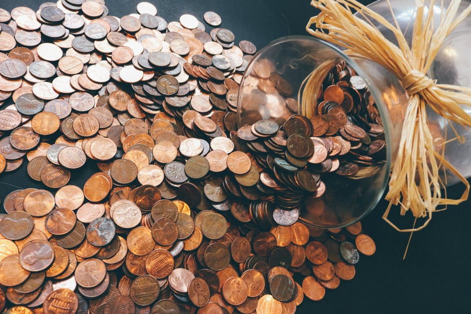 Coins spilling out of a jar