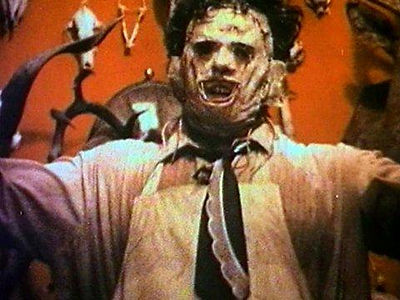 LeatherfacefromTexas Chainsaw Massacre 1974 with arms up