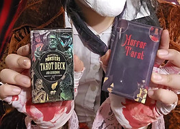 clown smiling holding tarot cards