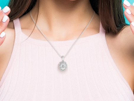 a woman wearing a halo diamond pendant necklace