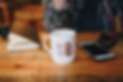 Ceramic mug on the table near to iPhone_Logo ROUGE.png