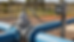 Close-up view of an electromagnetic flow meter with a telemetry enclosure on a pipe.