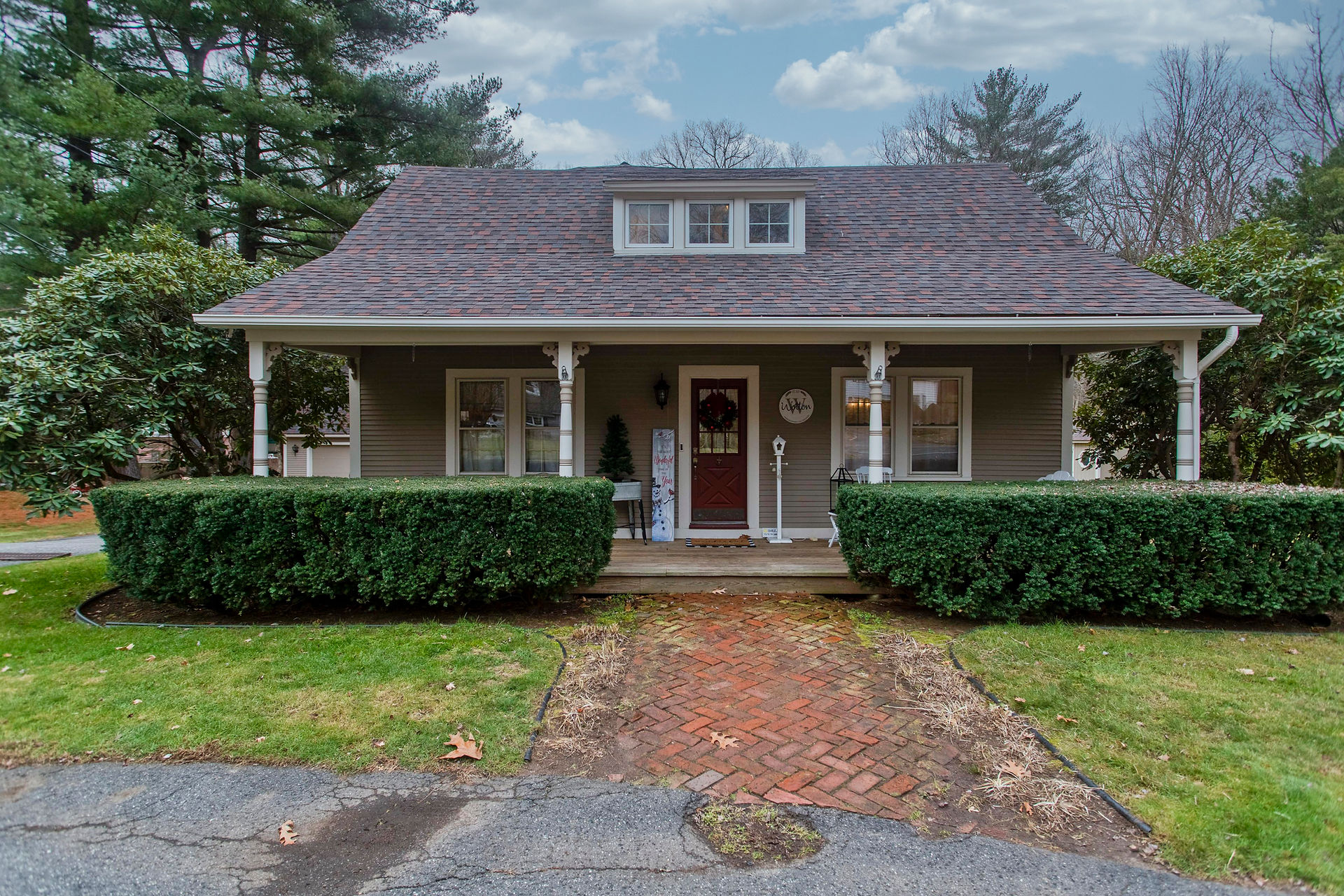 Cute front porch with brick walkway 
