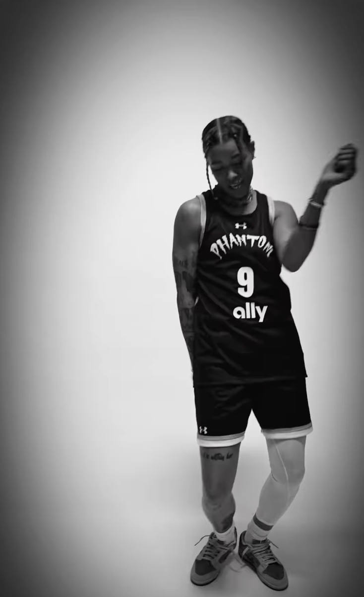 A black and white still of Tasha Cloud doing a dance move while wearing her Phantom BC uniform for Unrivaled media day.