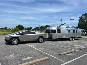 Classic 33 travel trailer and Cybertruck at the dealership lot