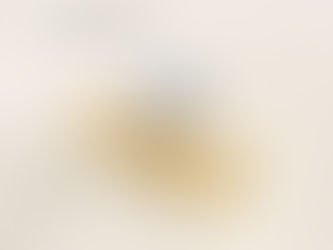 Pear shaped diamond on gold band with smaller diamonds across