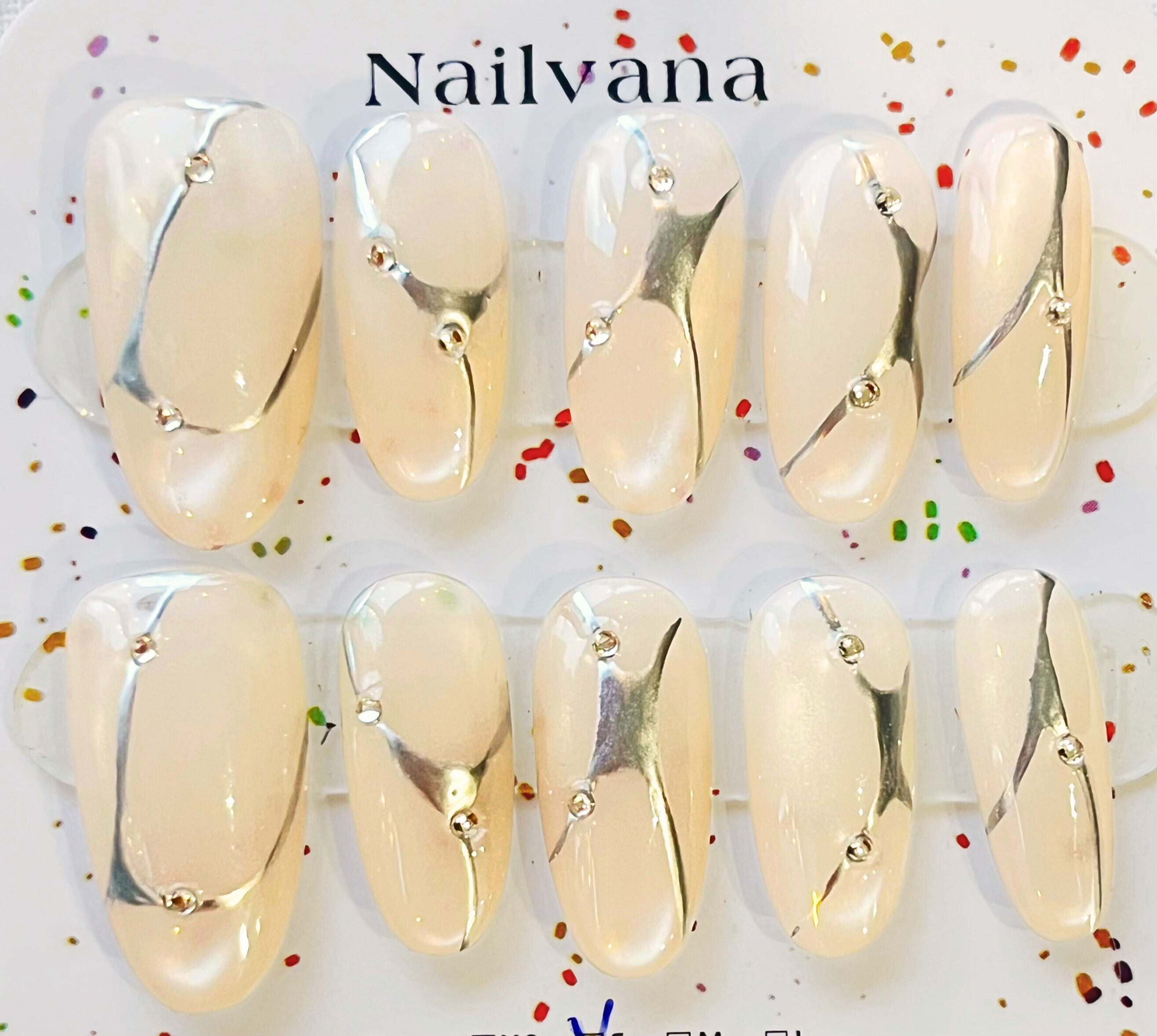 Nailvana nails with silver designs. Icy white cat eye nails. Elegant style.