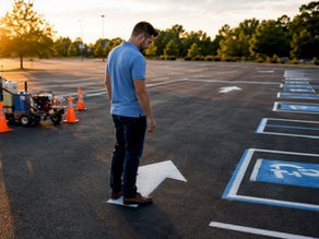 Property manager inspecting parking lot striping