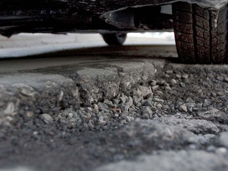 Vehicle affected by uneven pavement and construction zones in Richmond
