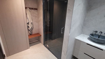 Glass door to a sauna room inside a bathroom