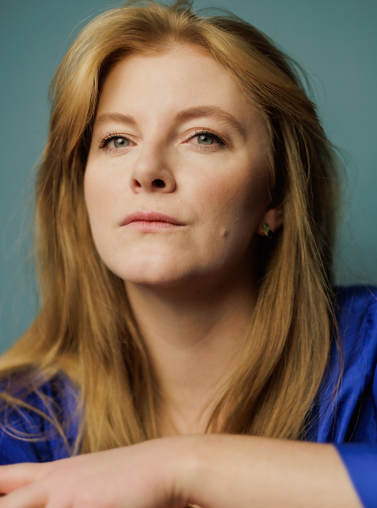 Ella is photographed close-up against a blue background