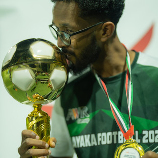 Sineo Packaging's Bakri from 'sineo synergy' team celebrating victory at AW Rostamani's 2024 Layaka Football Tournament - Corporate sports match