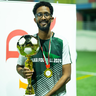 Sineo Packaging's Bakri from 'sineo synergy' team celebrating victory at AW Rostamani's 2024 Layaka Football Tournament - Corporate sports match