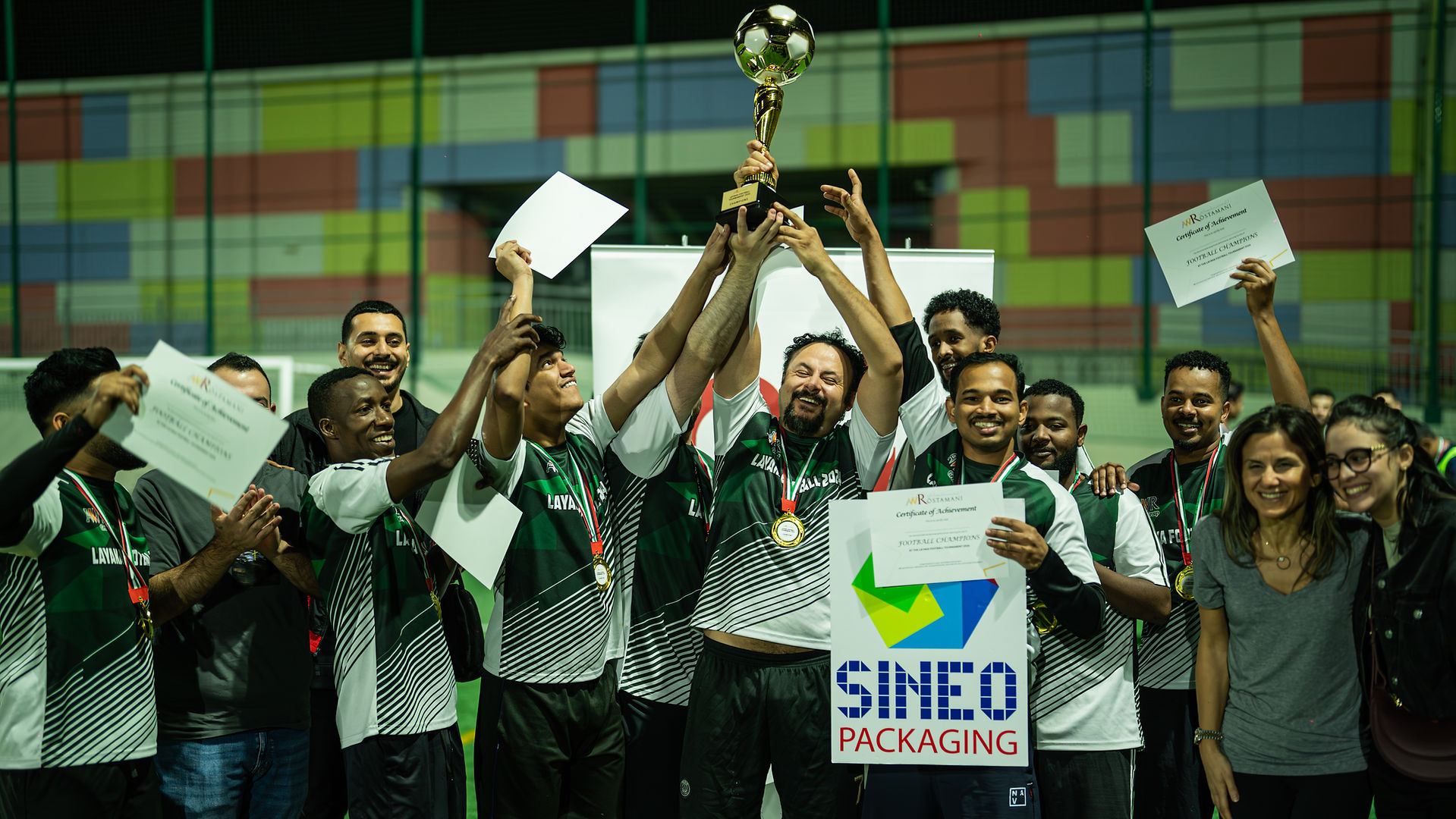 Sineo Packaging's 'sineo synergy' team celebrating victory at AW Rostamani's 2024 Layaka Football Tournament - Corporate sports match