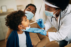 african-american-doctor-with-face-mask-examining-boy-s-throat-during-home-visit.jpg