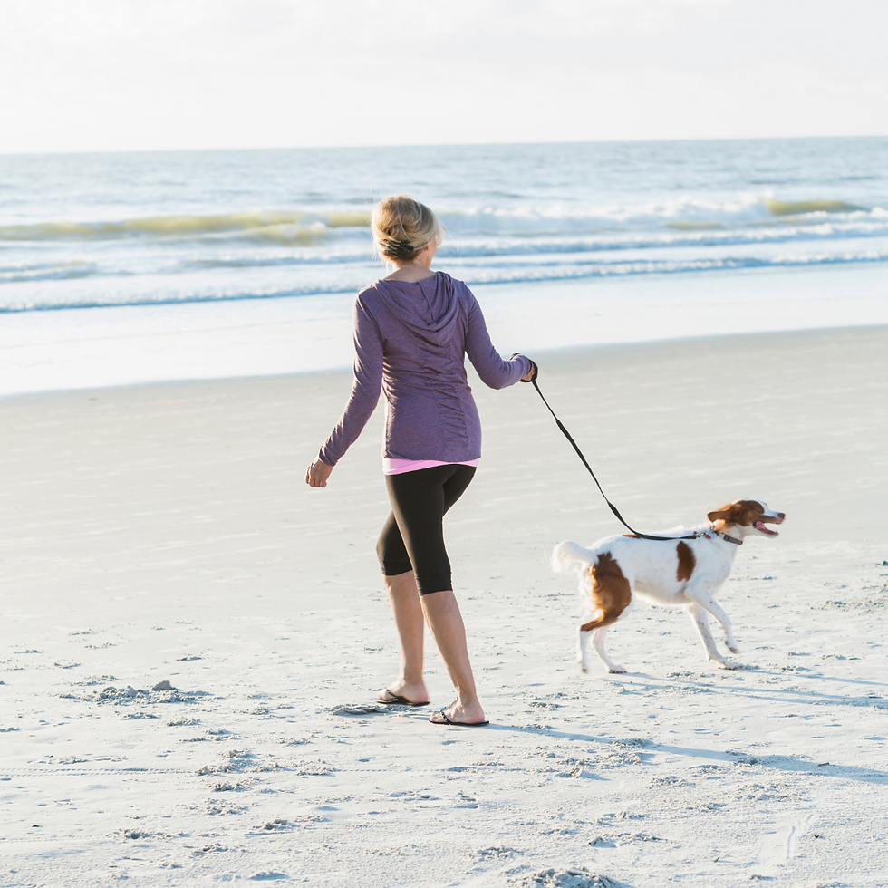 Woman exercising by walking her dog