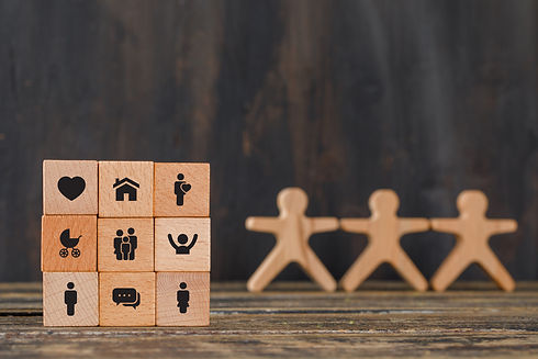 family-concept-with-icons-wooden-cubes-human-figures-wooden-table-side-view.jpg