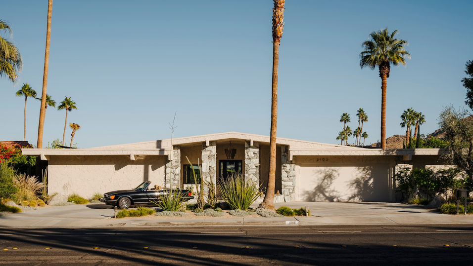 The exterior of a Mid-Century Marvel in Palm Springs, featuring an artistic chandelier above the front door
