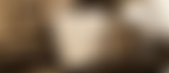 A charming vintage piano setup featuring Robert Schumann's "Album for the Young" sheet music, a traditional metronome, and a soldier figurine. The nostalgic ambiance is enhanced by a framed portrait, creating a timeless musical scene.