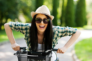 woman happy on bike energy smiling.jpeg