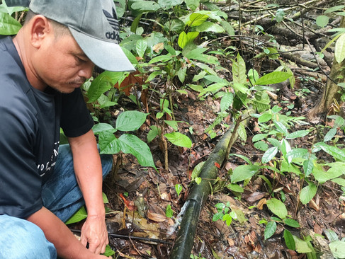 Efandi checking on the rural village's pipeline condition