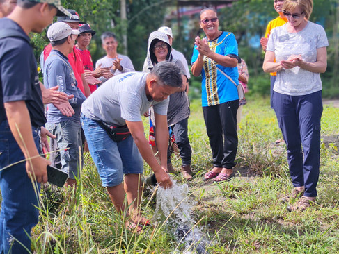 Happy villagers celebrating their successful water project execution