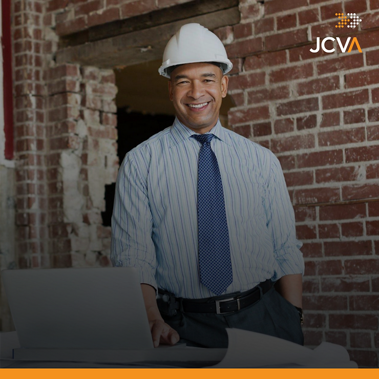 person smiling in corporate attire and a white hard hat