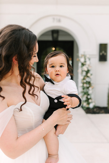 The Graily- Waxahachie. Bride holding baby in a tuxedo