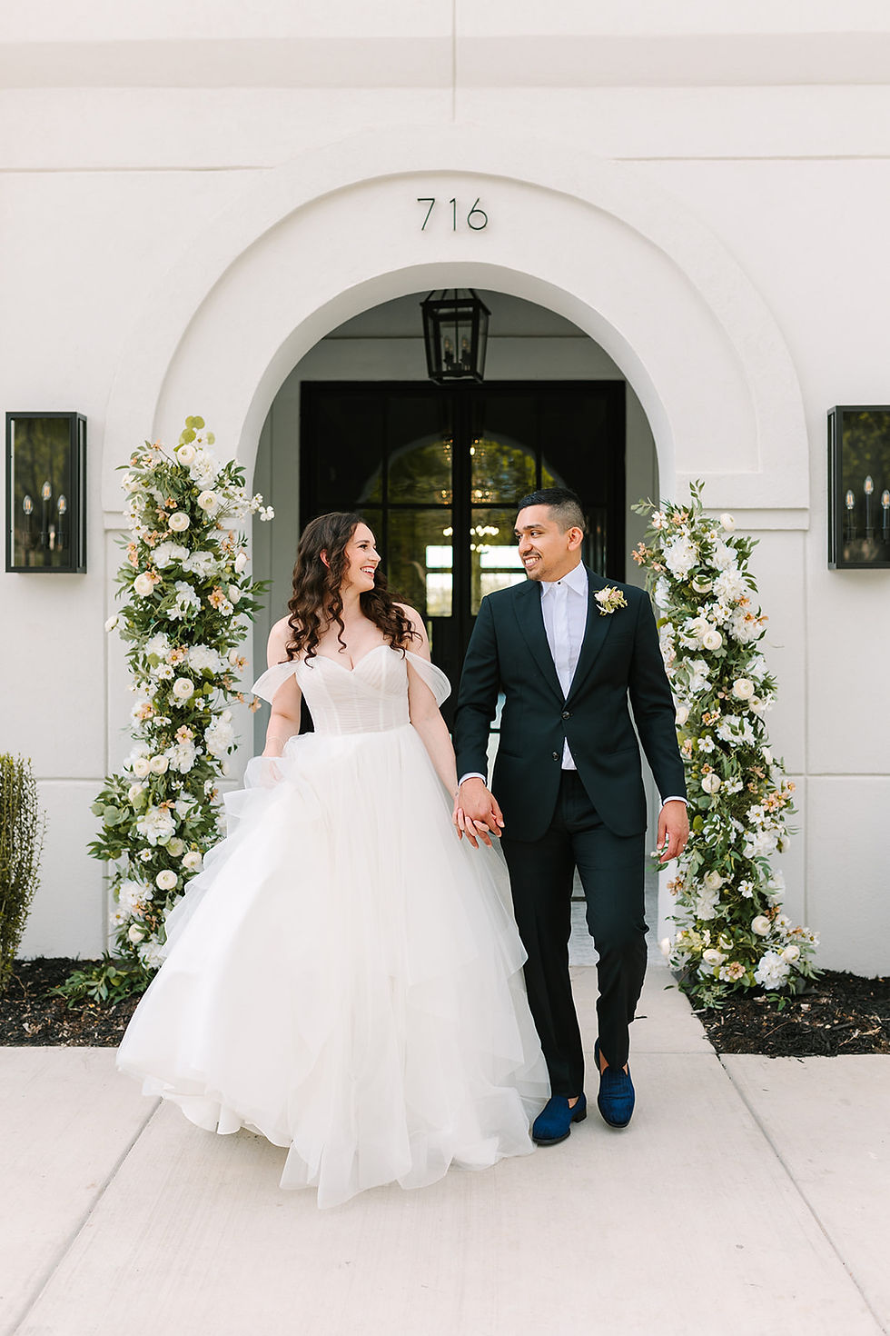 Bride and groom walking in front of The Graily