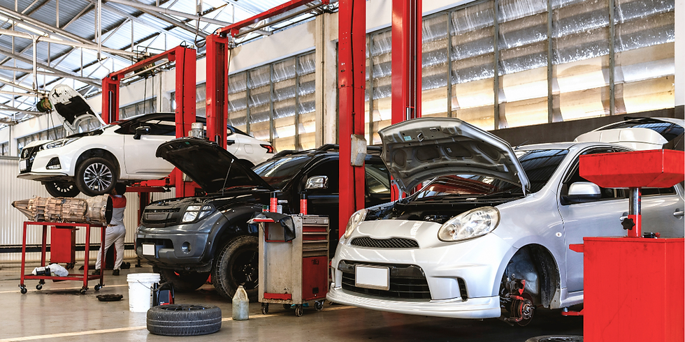 auto repair shop with cars on hydraulic lifts