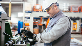 Worker operating machinery in a manufacturing facility