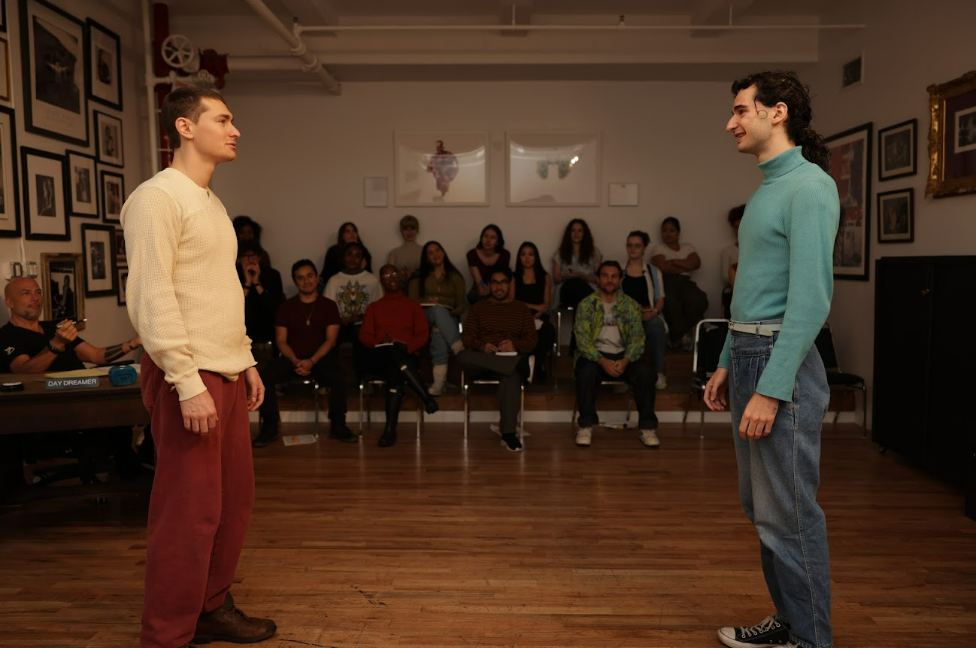 Two male actors practicing in a hall