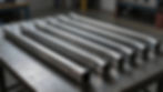 Bent rectangular chassis rails prepared for a custom automotive fabrication project.