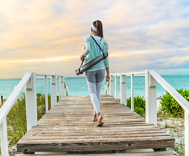 Woman carrying yoga mat